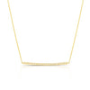 Yellow gold pave diamond bar necklace on a white background