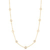Yellow gold necklace with thirteen round diamond stations on a white background