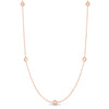 Rose gold necklace with five small round diamond stations on a white background