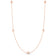 Rose gold necklace with five small round diamond stations on a white background