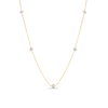 Yellow gold necklace with five small round diamond stations on a white background