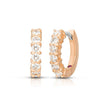 The CLASSIC DIAMOND HUGGY EARRINGS by Roberto Coin feature 18K rose gold hoops accented with a row of sparkling round white gemstones on the front, shown against a white background.