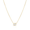 Yellow gold necklace with an emerald cut solitaire diamond pendant on a white background