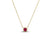 Gold chain necklace with round red gemstone pendant in gold bezel setting.