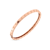 The Roberto Coin POIS MOI OVAL BANGLE, crafted in 18K rose gold, features a smooth band with evenly spaced round studs and is showcased against a plain white background.