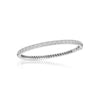 White gold bangle bracelet with diamonds on a white background