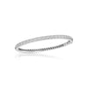 White gold bangle bracelet with diamonds on a white background