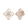 The PRINCIPESSA LARGE DIAMOND FLOWER EARRINGS by Roberto Coin feature four petal-shaped gold sections, each with a diamond center, creating a luxurious floral design displayed on a white background.