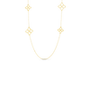 Zoomed in shot of a yellow gold chain necklace featuring open frame flower stations, shown on a white background