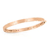 The LOVE IN VERONA NARROW WIDTH BANGLE by Roberto Coin features an engraved floral pattern and a small pink gem inside, shown against a white background, radiating timeless sophistication.