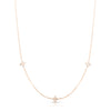 Rose gold necklace with three diamond flower stations on a white background