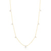 Yellow gold necklace with 7 diamond flower stations on a white background