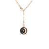 Rose gold chain necklace with half-moon pendant featuring black and white diamonds.