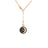 Rose gold chain necklace with half-moon pendant featuring black and white diamonds.