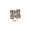 The Roberto Coin VENETIAN PRINCESS DIAMOND AND TITANIUM FLOWER RING showcases a rose gold clover design with four matte black petals, diamond accents, and detailed edges for a modern, elegant look on a plain white background.