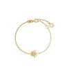 Yellow gold flower bracelet with diamond accent on a white background