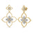 Yellow gold open frame double flower dangle earrings with diamond accents on a white background