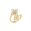 Side view of yellow and white gold open frame double flower ring with diamond accents on a white background