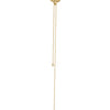 Yellow and gold lariat necklace with flower pendant and diamond accents ends on a white background