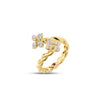 Side view of yellow gold twist bypass ring with diamond flower ends on a white background