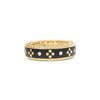 Front view of yellow gold and black enamel ring with diamond accents on a white background