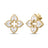 Yellow gold and white enamel flower stud earrings with diamond accents on a white background