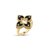 Side view of yellow gold and black enamel flower ring with diamond accents on a white background