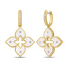 Yellow gold and white enamel flower dangle earrings with diamond accents on a white background