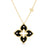 Yellow gold and black enamel flower necklace with diamond accents on a white background