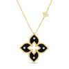 Yellow gold and black enamel flower necklace with diamond accents on a white background