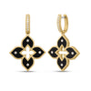 Yellow gold and black enamel flower dangle earrings with diamond accents on a white background