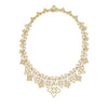 Yellow old open frame multi-flower collar necklace with diamond accents on a white background
