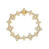 Yellow old open frame multi-flower bracelet with diamond accents on a white background