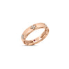 Side view of rose gold ring with diamond floral motif accents on a white background