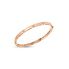 Rose gold bangle with diamond floral motif accents on a white background