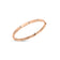Rose gold bangle with diamond floral motif accents on a white background