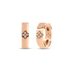 Rose gold hoop earrings with diamond floral motif accent on a white background