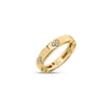 Side view of yellow gold ring with diamond floral motif accents on a white background