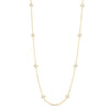 Yellow gold long necklace with mother of pearl flower stations on a white background