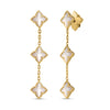 Yellow gold dangle earrings with mother of pearl flower stations on a white background