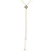 Yellow and white gold necklace with diamond flower charm on a white background
