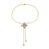 Yellow and white gold bracelet with diamond flower charm on a white background