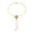 Yellow and white gold bracelet with diamond flower charm on a white background
