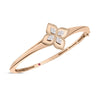 The PRINCESS FLOWER DIAMOND KNIFE EDGE BANGLE by Roberto Coin features a central four-petal flower with white gemstones, delicate petal details, a small red accent inside, and engraved text that reflects Italian craftsmanship.