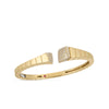 The OBELISCO PAVE DIAMOND ENDS BANGLE by Roberto Coin is a gold open cuff with ridged segments and square ends, each set with pavé diamonds, showcasing modern Italian elegance. Photographed on a white background.
