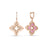 The VENETIAN PRINCESS PIROUETTE Medium Flower Drop Earrings by Roberto Coin Staging feature 18K gold, one with a pink enamel center and the other with diamond accents, both sparkling with small diamonds along the hoops.