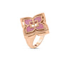 The VENETIAN PRINCESS PIROUETTE PAVE FLOWER RING by Roberto Coin Staging is an 18K gold ring with a large square flower, pink enamel petals, and a central gemstone, shown on a white background.