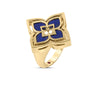The VENETIAN PRINCESS PIROUETTE PAVE FLOWER RING by Roberto Coin Staging features a bold flower design with blue enamel or stone inlays on a plain gold band, shown against a white background.