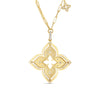 The VENETIAN PRINCESS PIROUETTE LARGE FLOWER NECKLACE by Roberto Coin features an ornate 18K gold four-petal pendant with diamond accents on an elongated link chain, plus a matching charm near the clasp, exemplifying Italian craftsmanship.