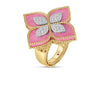 The VENETIAN PRINCESS DIAMOND AND RHODONITE LARGE FLOWER RING by Roberto Coin features 18K gold, a rhodonite centerpiece, diamond-studded white gold petals, and intricate detailing along the band and edges.